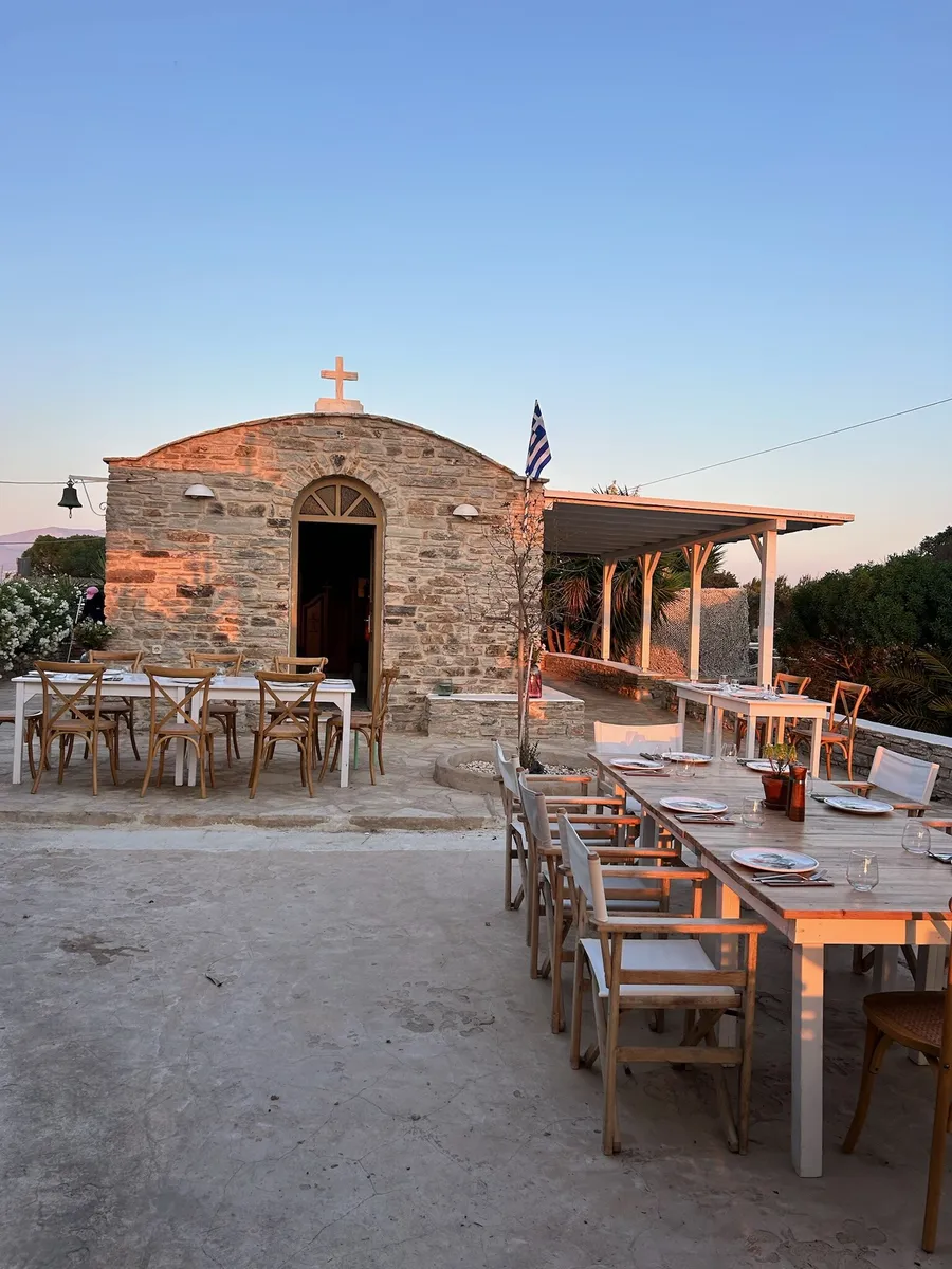 Long tables set beside a small stone chapel